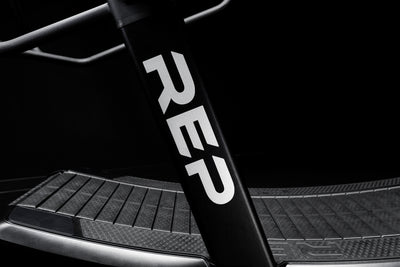 The REP Fitness branding on the side of the Strive Curved Treadmill