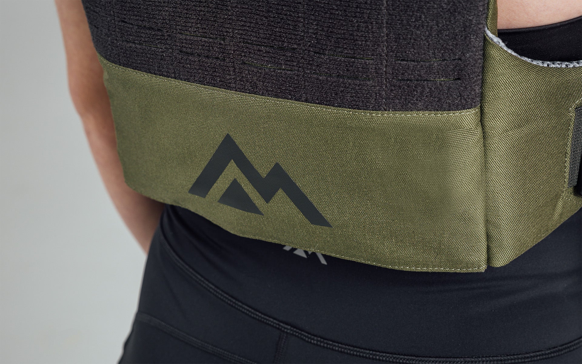Mountain logo on the back bottom of the Strata Weight Vest