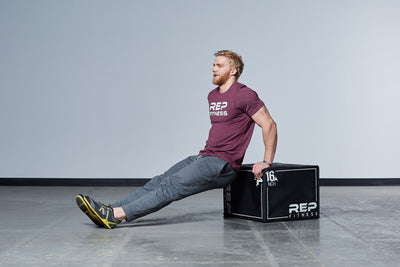 Individual performing dips on the Medium REP 3-in-1 Soft Plyo Box.