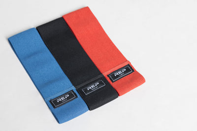 Full set of REP circle hip bands: light red, medium black, and heavy blue.