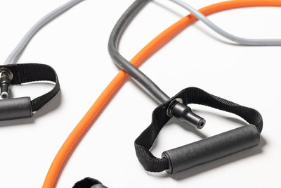 Close-up view of each colored tube resistance band attached to one end's handle.